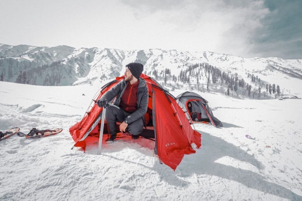 A man sitting in a dome tent