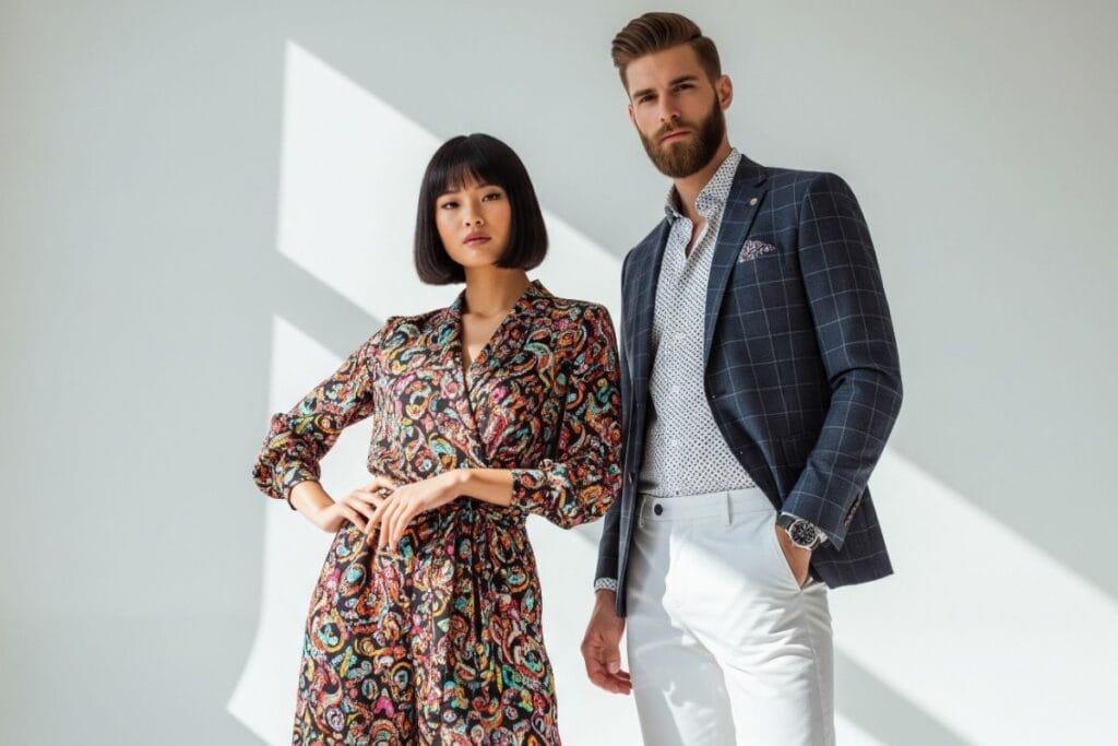 A woman is wearing a wrap dress, and a man is wearing blazer from Buckmason