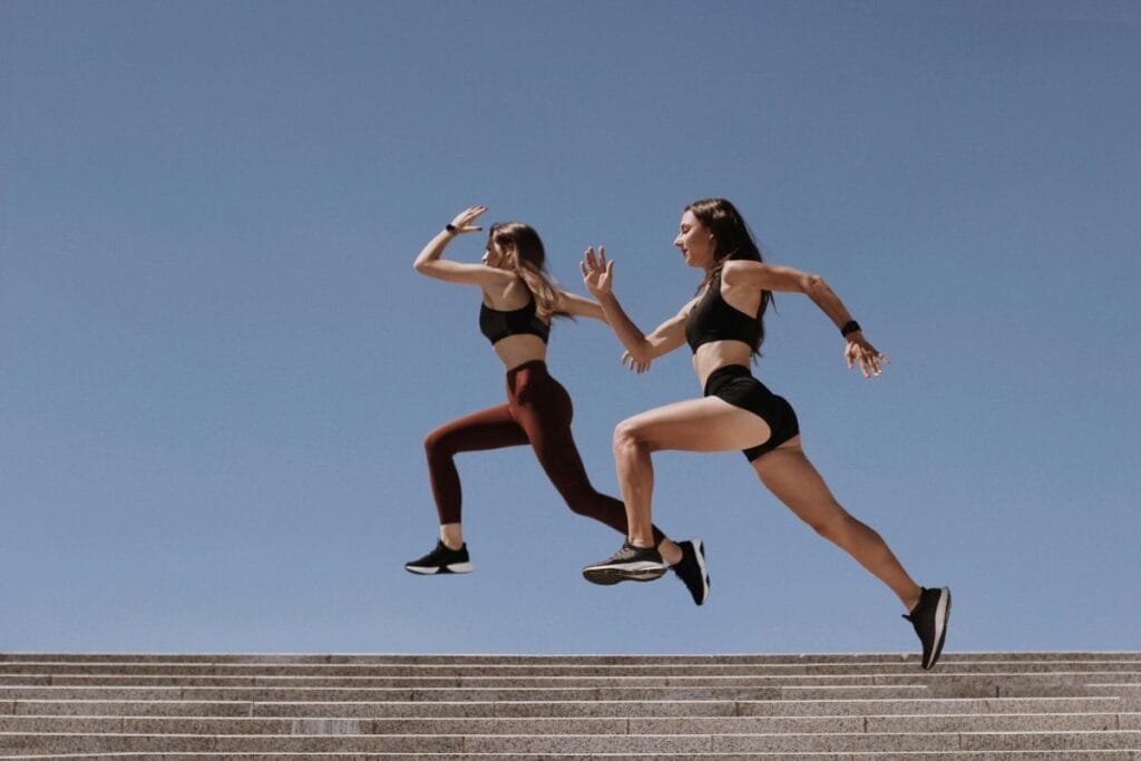 Two women enjoying a run in stylish, comfortable sportswear and athletic shoes.