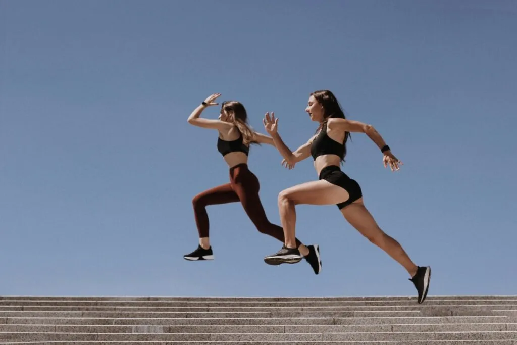 Two women enjoying a run in stylish, comfortable sportswear and athletic shoes.