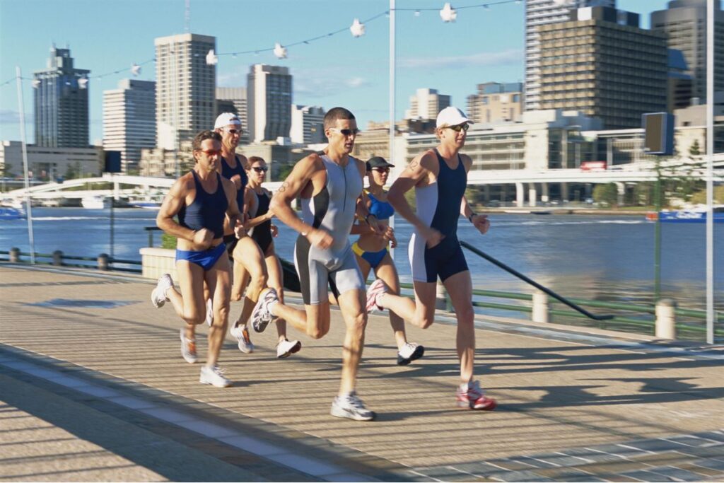 A group of people running in comfortable shoes and sportswear from Fleet Feet.