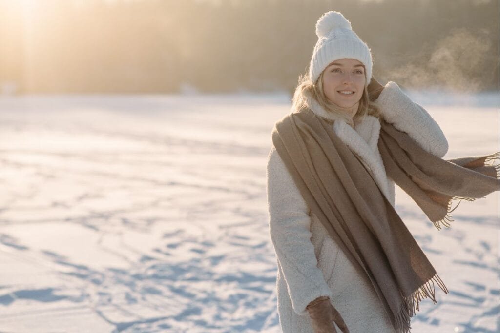 A woman in a white fleece jacket enjoying the cold weather