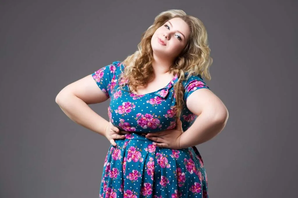 A Woman dressed in a vibrant floral dress.