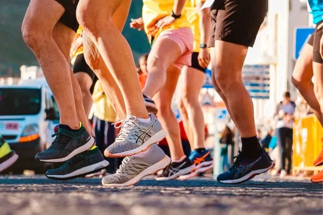 A group of runners in Asics shoes