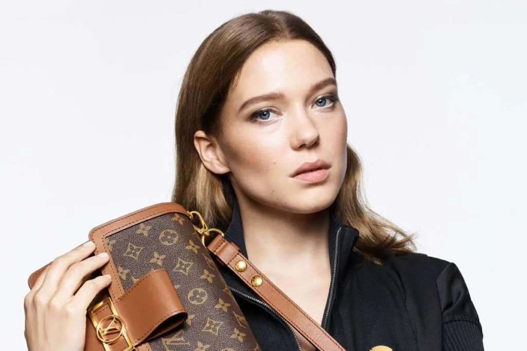 A woman holding classy Louis Vuitton Bag