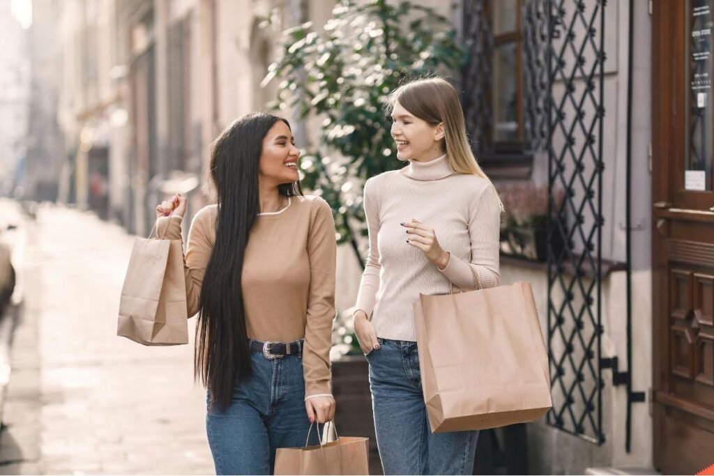 Friends carrying shopping bags with Big smiles on their face
